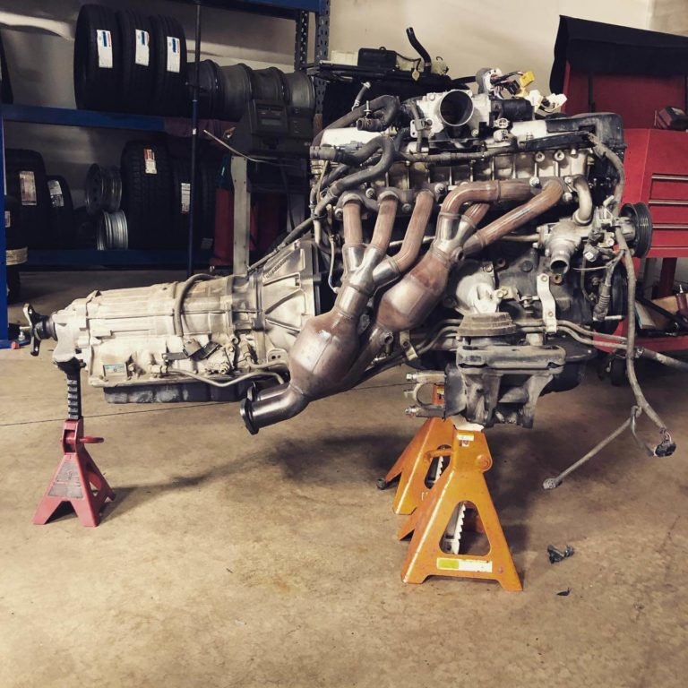 Engine & Transmission Replacement at Ace Performance, Gilbert, AZ.; An engine sitting on-top of equipment, waiting to be repaired
