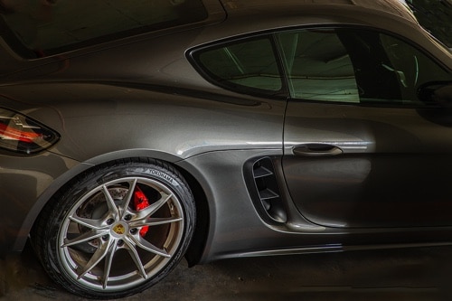 A Look at Touring Tires vs. Performance Tires for Your Car with Ace Performance Automotive in Gilbert AZ closeup image of Yokohama brand performance tires on gun metal gray Porsche