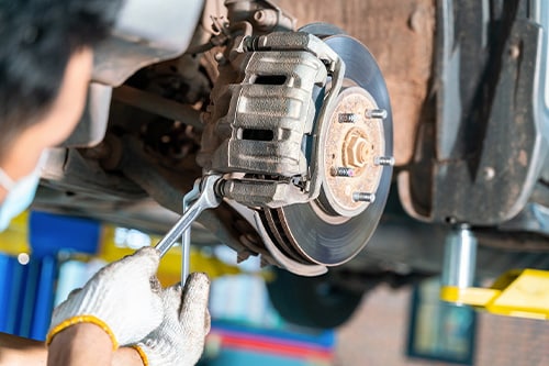 Car brake repairing in garage at auto repair service center