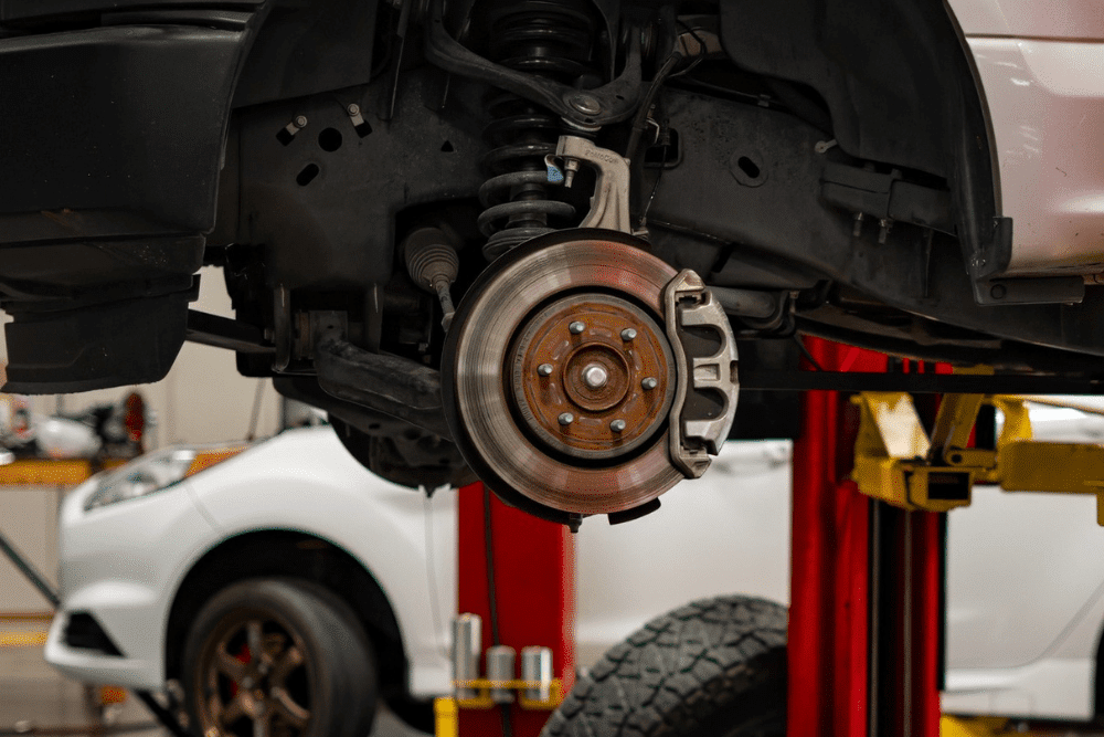 Brake inspections in Queen Creek, AZ by APA Total Car Care. Image of a vehicle’s brake rotor and caliper exposed during service, highlighting the shop’s commitment to safety, stopping power, and reliable brake performance.