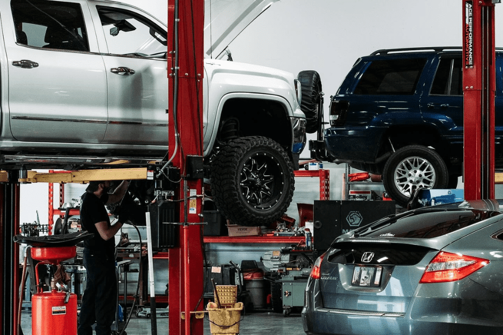 Fall car maintenance, auto repair in Queen Creez, AZ by APA Total Car Care. Image of multiple vehicles on lifts inside a professional repair facility, representing the shop’s dedication to precision, quality workmanship, and complete auto care for every customer.